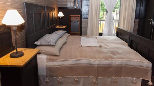 a bedroom with a large bed and a table and a lamp at Torino Mon Amour in Turin