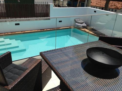 a pool with a table and a bowl on top of it at Casa do Joaquim da Praia in Nazaré