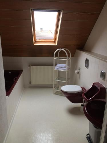 La salle de bains est pourvue de toilettes et d'une fenêtre. dans l'établissement Moments Apartment, à Rust