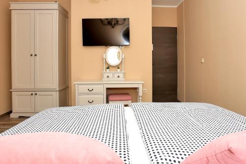 a bedroom with a bed with a mirror and a dresser at Shabby chic rooms in Zadar