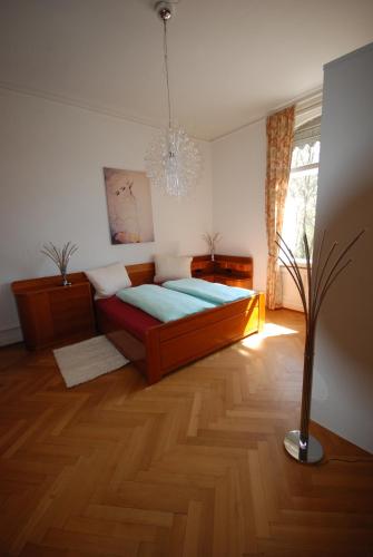 um quarto com uma cama e um vaso no chão em Appartements in zentraler Lage em Tübingen