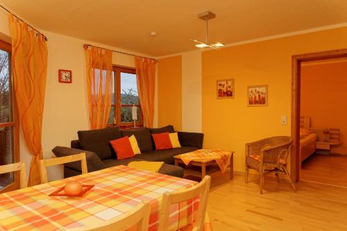 a living room with a couch and a table at Ferienwohnung Kaufmann in Baiersbronn