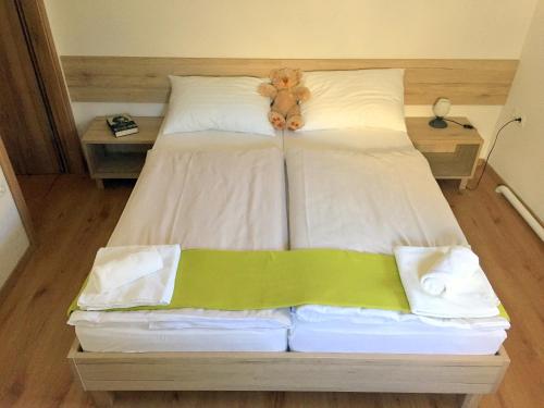 een teddybeer op een bed bij Apartmaji in sobe Tina in Kranjska Gora