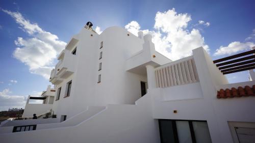 a white building with the sky in the background at Surfers Retreat in Corralejo