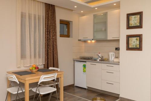 a small kitchen with a table and a table and chairs at Apartment Milmari Sunny View G3 in Kopaonik