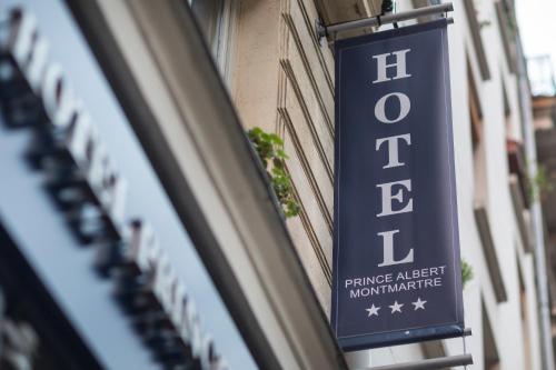 a blue sign on the side of a building at Prince Albert Montmartre in Paris