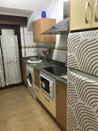 A kitchen or kitchenette at Apartamentos Costa Noja