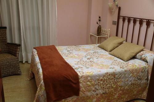 A bed or beds in a room at Apartamentos Costa Noja