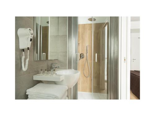 a bathroom with a sink and a shower at Hotel Gardenia in Lido di Jesolo