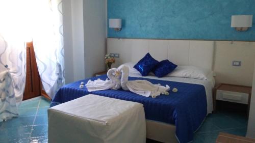 a hotel room with two beds with towels on them at Le Perle d'Italia in Ravello