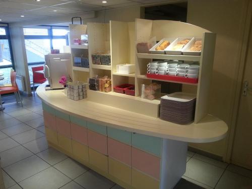 A kitchen or kitchenette at Premiere Classe Lyon Est Aeroport Saint Exupery