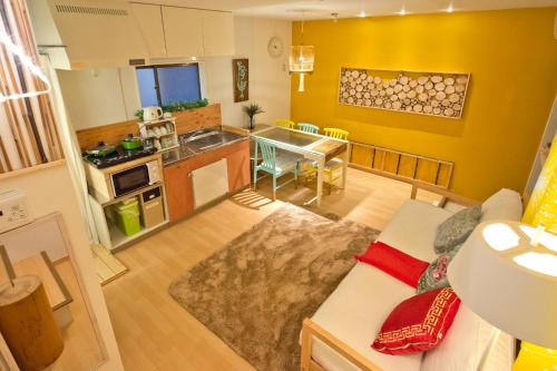 a kitchen and living room with a couch and a table at Lucy's House横浜中華街 House1 in Yokohama