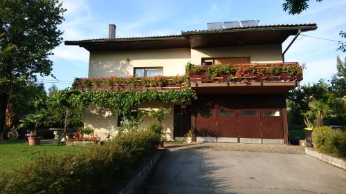 ein Haus mit Blumenkästen an der Seite in der Unterkunft Apartment & rooms Grmek in Postojna