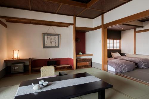 Кровать или кровати в номере Takamiya Ryokan Miyamaso