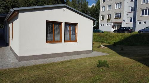 a rendering of a small white building with a window at Apartmán Srní in Srní