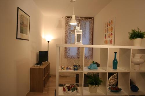 a living room with a white shelf and a tv at Casa Palladio in Vicenza