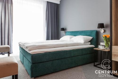 Una cama o camas en una habitación de Gdynia Centrum