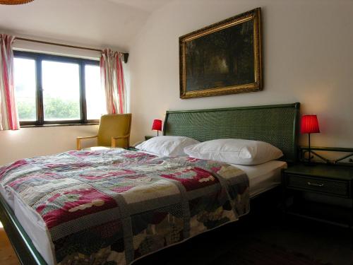 a bedroom with a bed and a picture on the wall at Haus Wartenberg in Salzburg