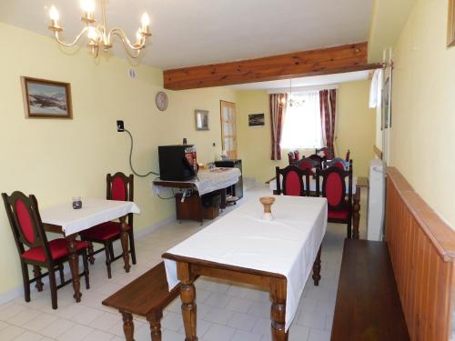 a room with tables and chairs and a piano at Penzion Kalina in Tábor