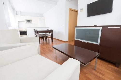 a living room with a couch and a table at Domocenter Apartamentos Turísticos in Bormujos