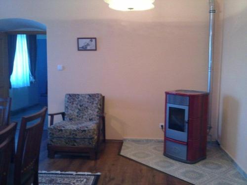 a living room with a tv and a chair at Statek Kloubek in Chabičovice