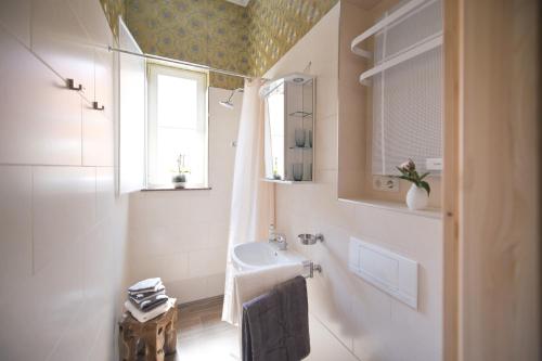 a bathroom with a sink and a window at Guest house Villa Fritz in Potsdam