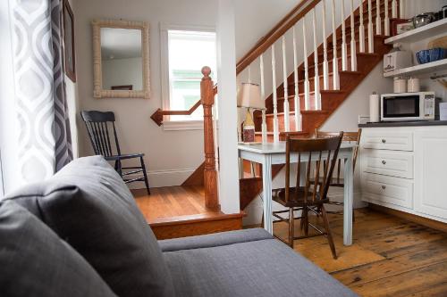 a living room with a couch and a table with a microwave at Salt Shaker Deli & Inn in Lunenburg