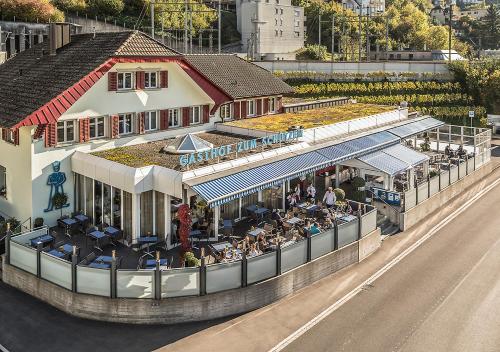 an overhead view of a building with people sitting outside at Gasthof zum Schützen in Aarau