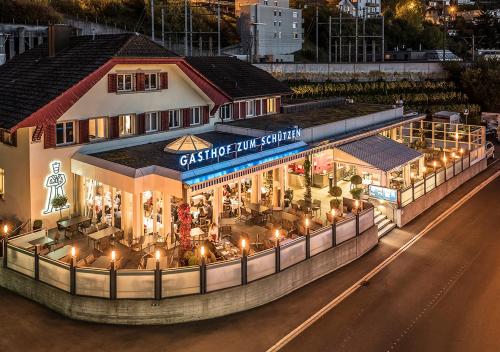 a store front with lights on a street at night at Gasthof zum Schützen in Aarau