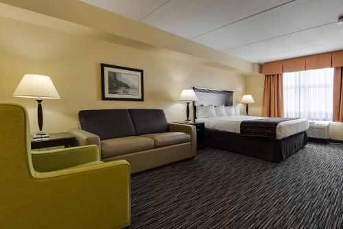 een hotelkamer met een bed en een bank bij Country Inn & Suites by Radisson, Niagara Falls, ON in Niagara Falls