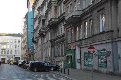 une rue avec des voitures garées sur le côté d'un bâtiment dans l'établissement Ada Aparthouse, à Wrocław