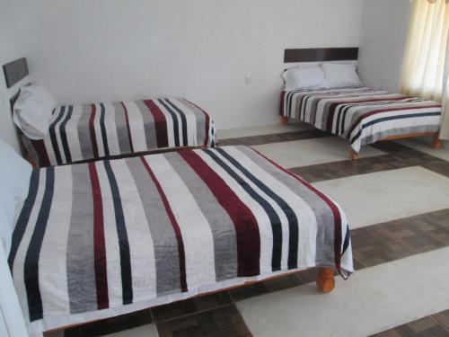 A bed or beds in a room at Hotel Pedregal