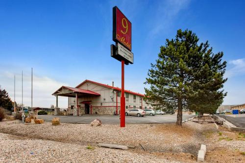 a gas station with a sign in front of it at 9 Motel in Fort Collins