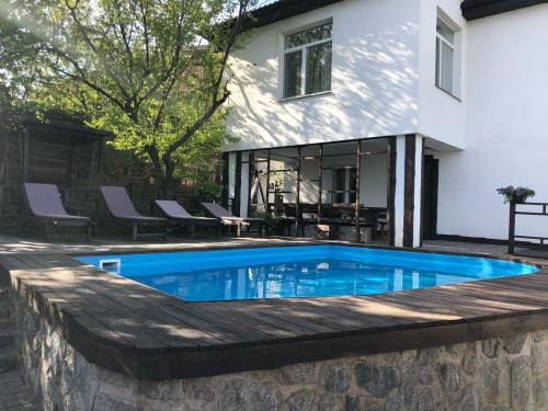 a swimming pool in front of a house at Dniprovskiy Dvir in Dnipro