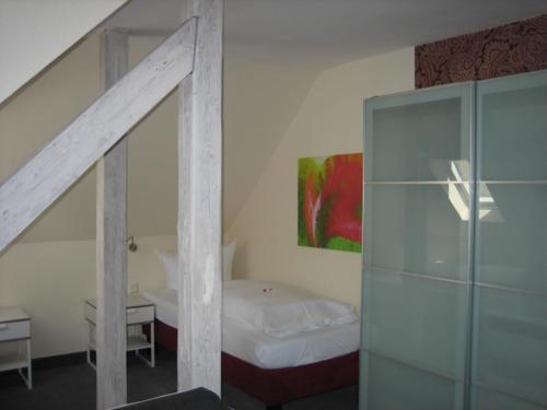 a bedroom with a bed and a staircase in a room at BSW Ferienhotel Lindenbach in Bad Ems