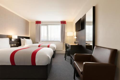 A bed or beds in a room at Ramada Chorley South