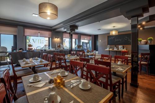 a dining room with tables and chairs and a restaurant at Park Hotel Airport in Charleroi