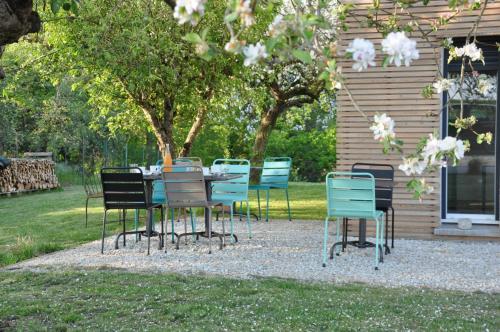 un groupe de chaises et une table devant une maison dans l'établissement L'Atelier, à Sainte-Marie-du-Lac-Nuisement 