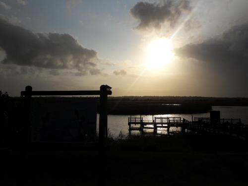 a sun is setting over a body of water at African Dreamz Guest House in St Lucia