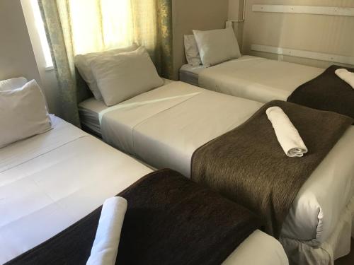 A bed or beds in a room at Businessburg Hotel