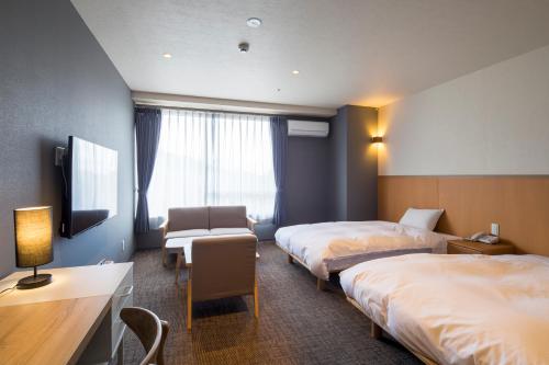 Tempat tidur dalam kamar di Sundance Resort Atami