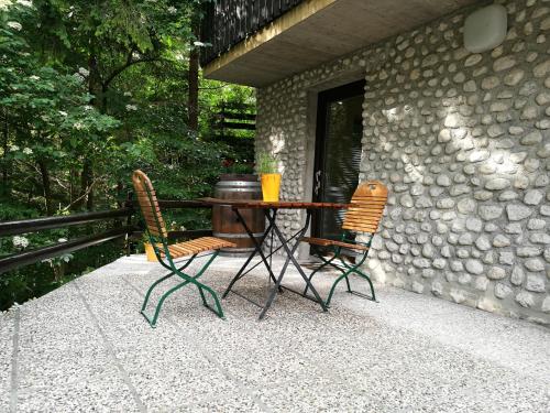 twee stoelen en een tafel op een patio bij Apartments Jelka in Kranjska Gora