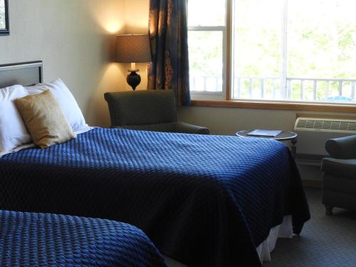 A bed or beds in a room at Admiral Digby Inn Restaurant and Cottages