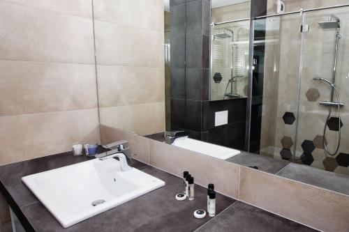 a bathroom with a sink and a shower at Apartament "Park Lotników" in Kraków