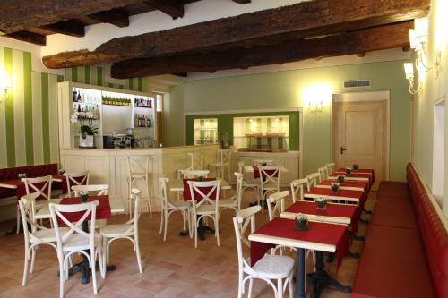 a restaurant with red and white tables and chairs at Hotel Borgo Antico in Como