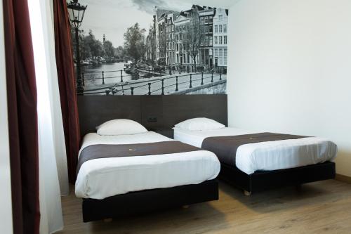 Postel nebo postele na pokoji v ubytování Bastion Hotel Amsterdam Amstel