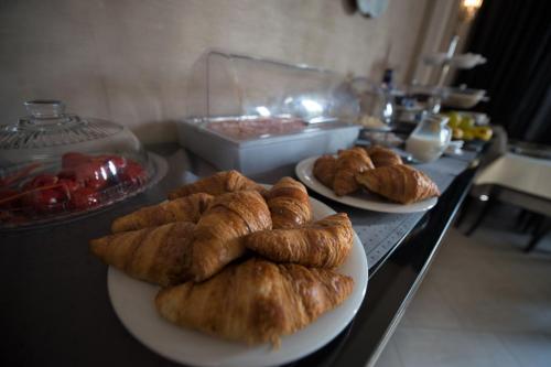 two plates of croissants sitting on a table at Pensiunea Nora Prestige in Timişoara