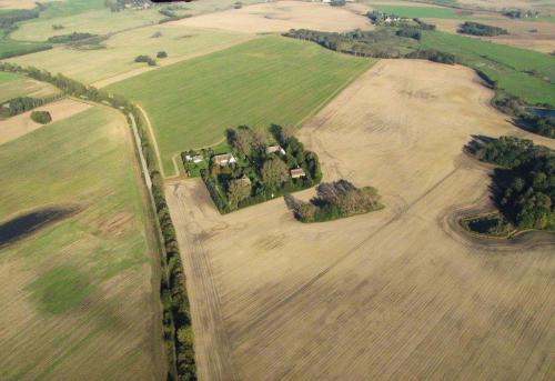 an aerial view of a farm in a field at Die Insel auf Rügen in Rambin