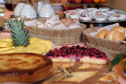 a table with many different types of bread and pastries at Hotel Adria in Bari