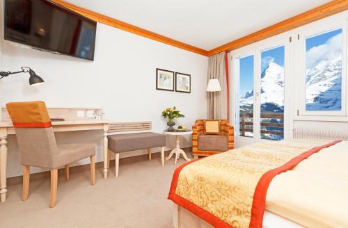 Ein Bett oder Betten in einem Zimmer der Unterkunft Eiger Mürren Swiss Quality Hotel